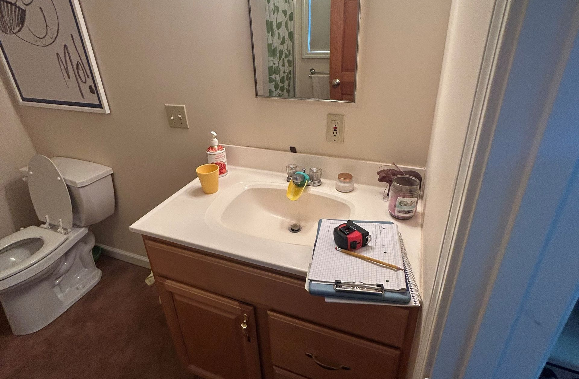 Modern bathroom with wooden vanity, large mirror, marble shower, and flooring. Modern bathroom with wooden vanity, large mirror, marble shower, and flooring.