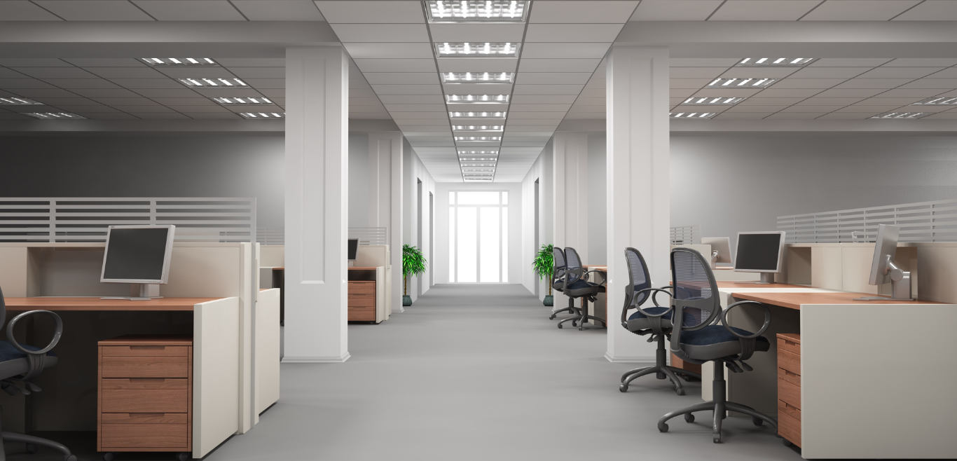 An empty office with cubicles , desks , chairs and computers.