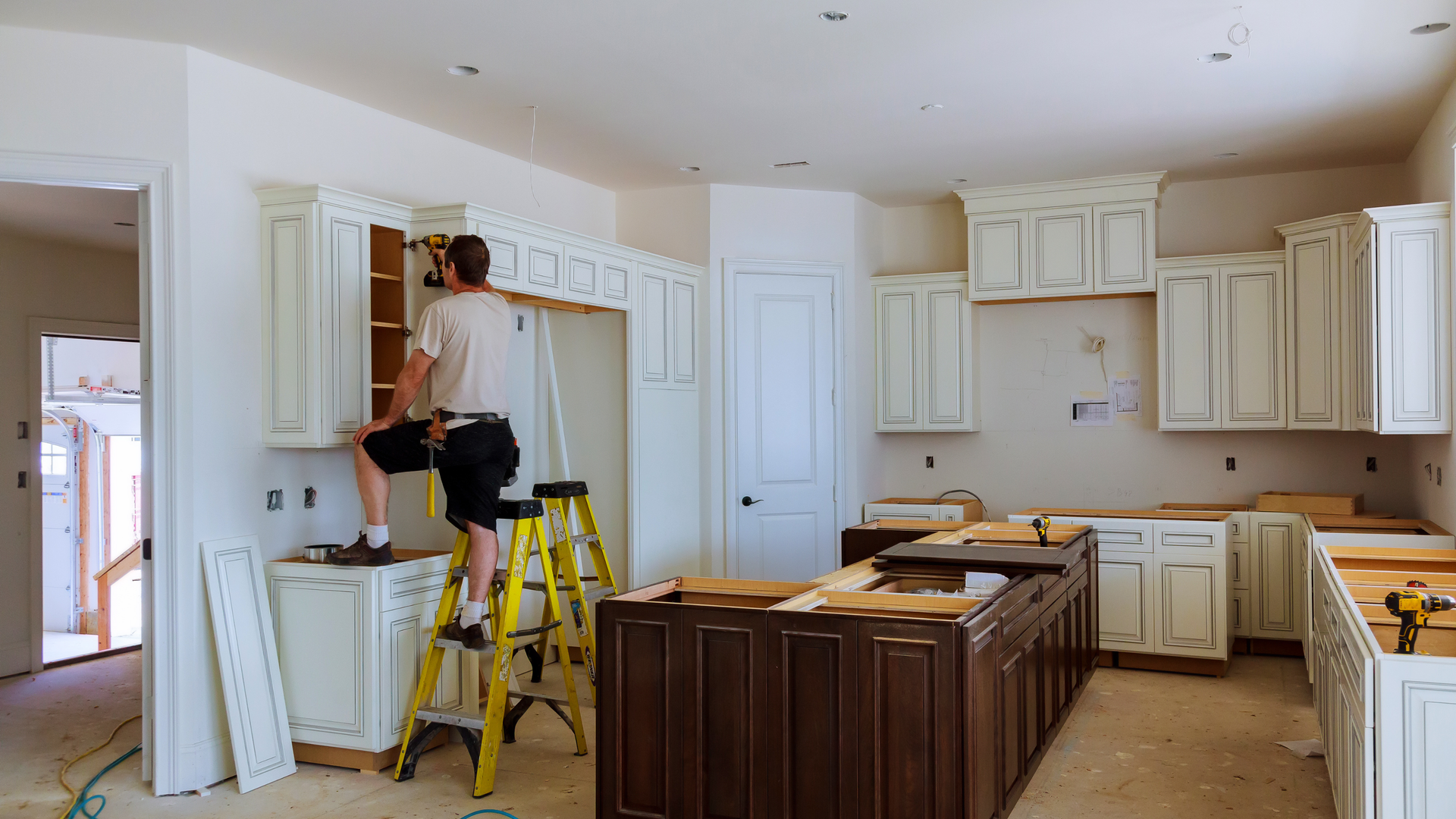 Modern kitchen with wood cabinets, stainless steel appliances, and island.