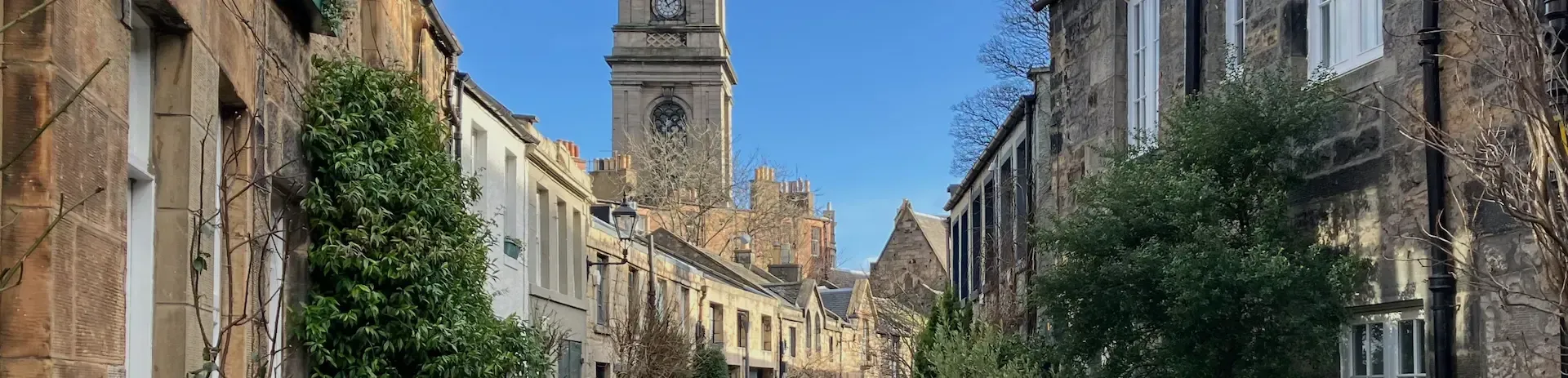 Stone houses and floral displays on Circus Lane, a picturesque spot on an Edinburgh guided walking tour.