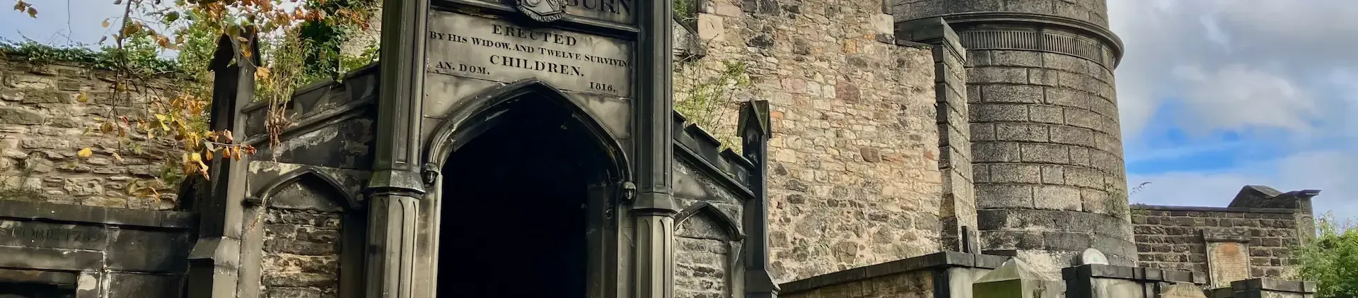 Local guide Lewis leading a private walking tour through historic Edinburgh graveyard.