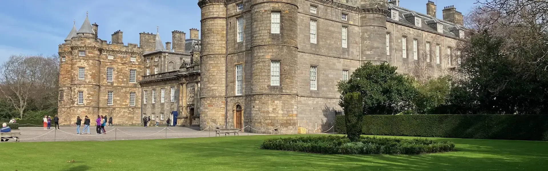 Tour guide Lewis leading a private walking tour past the Palace of Holyroodhouse.