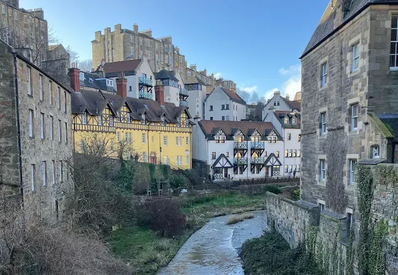 Picturesque view of Dean Village stone houses and the Water of Leith during an Edinburgh Architectural Walking Tour.