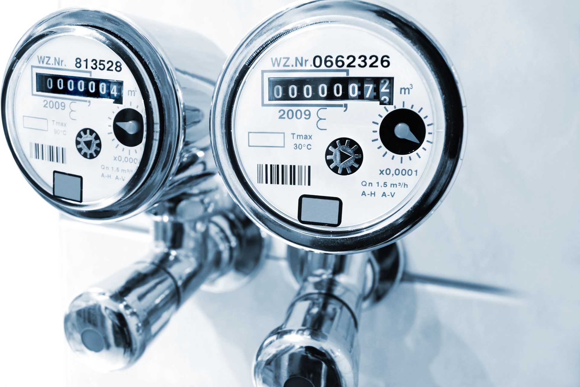 Two water meters are sitting next to each other on a white surface.| Kansas City, KS | APA Two water meters are sitting next to each other on a white surface.| Kansas City, KS | APA