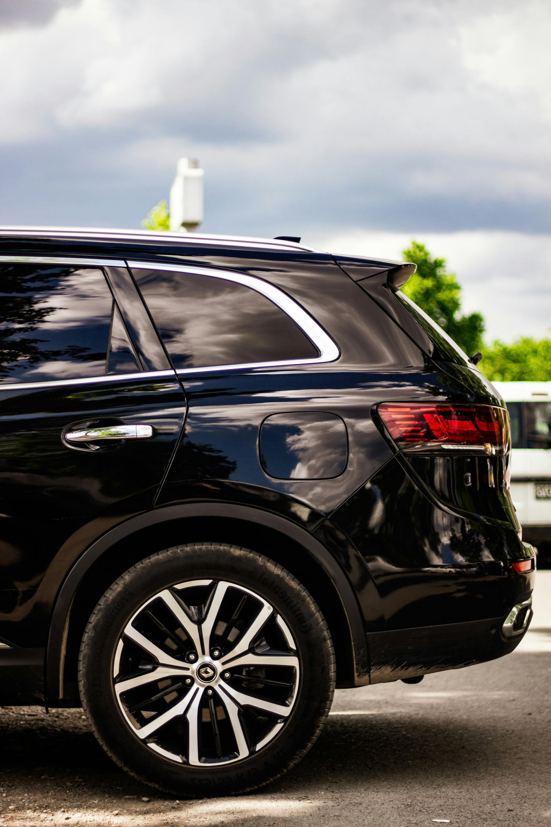 A black suv is parked in a parking lot.