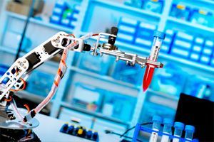 A robotic arm holds a test tube in a laboratory.