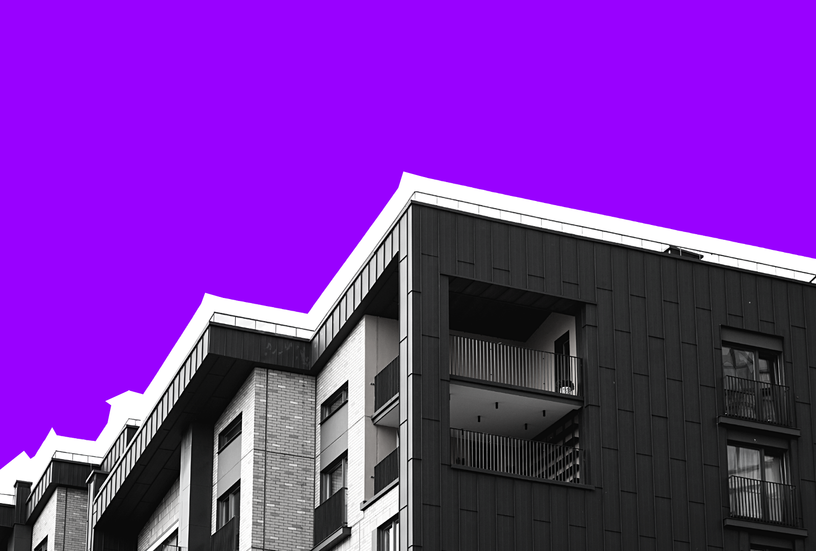Modern building with black exterior and purple sky background.