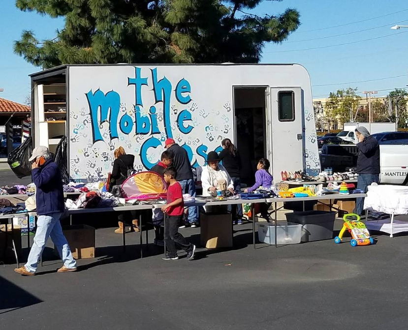 Crowd looking through items donated to the mobile closet