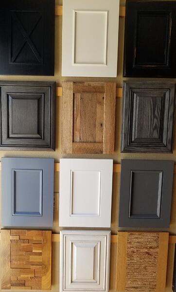 A grid of 12 cabinet door panels in black, white, gray, and wood finishes.