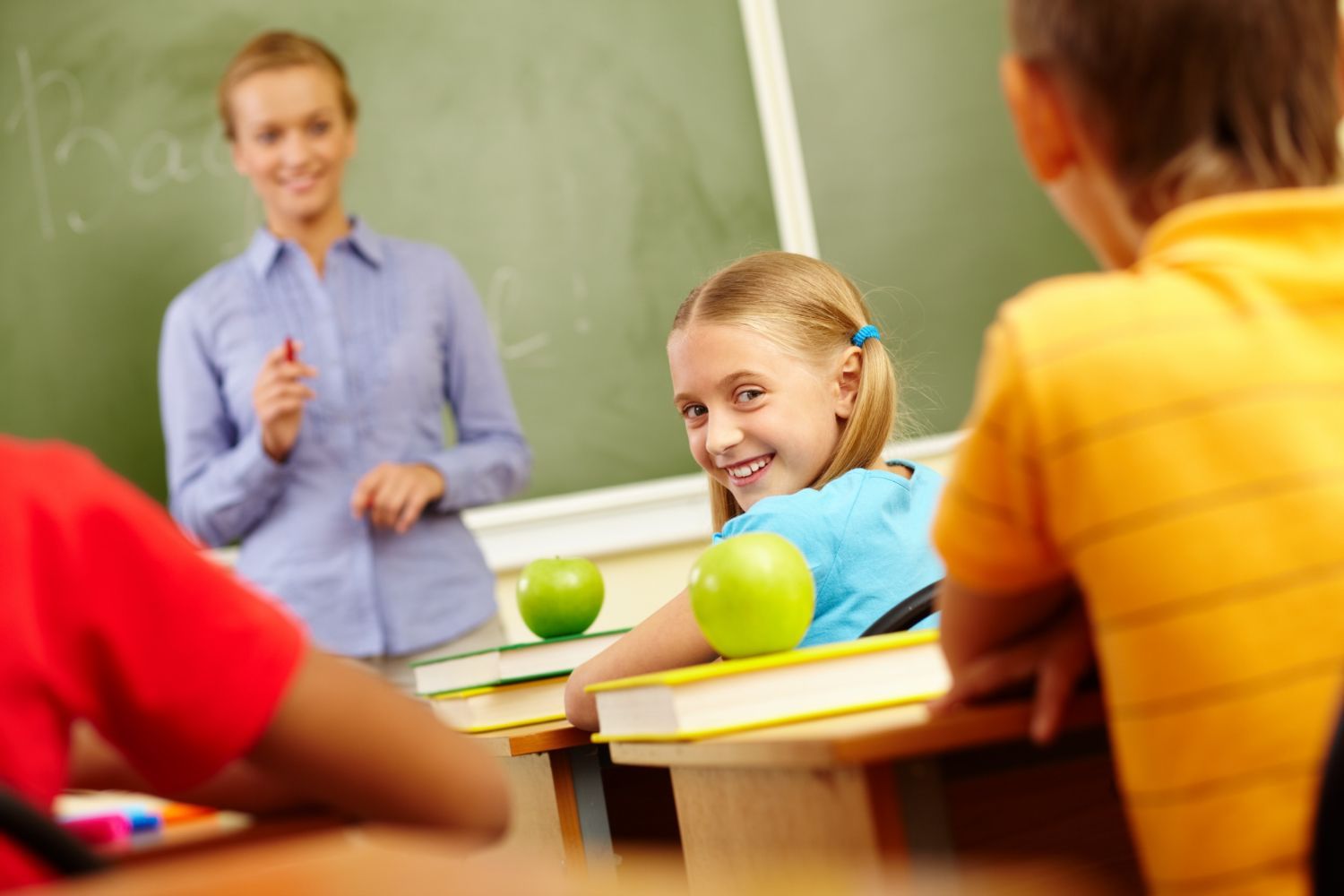 A teacher is giving a presentation to her students in a classroom.