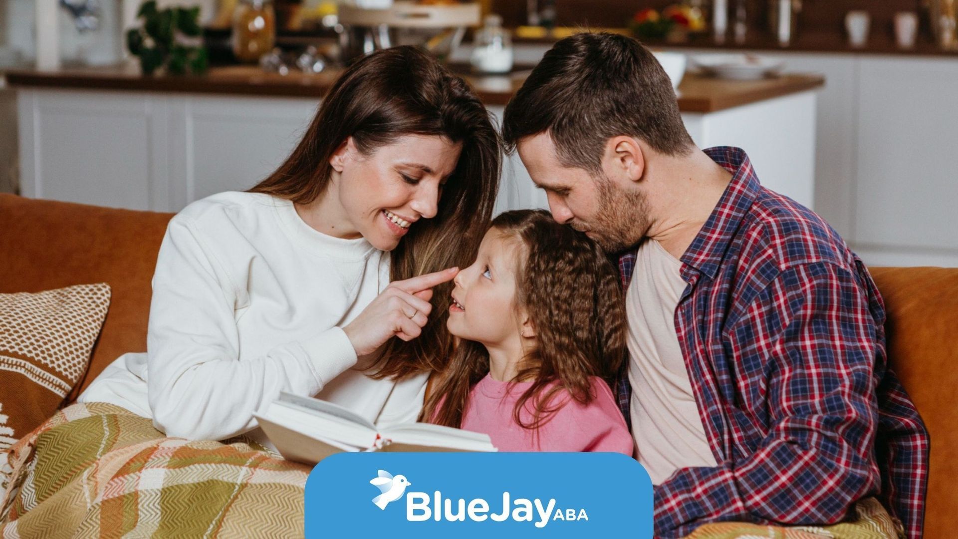 Parents read a book with their autistic child at home.
