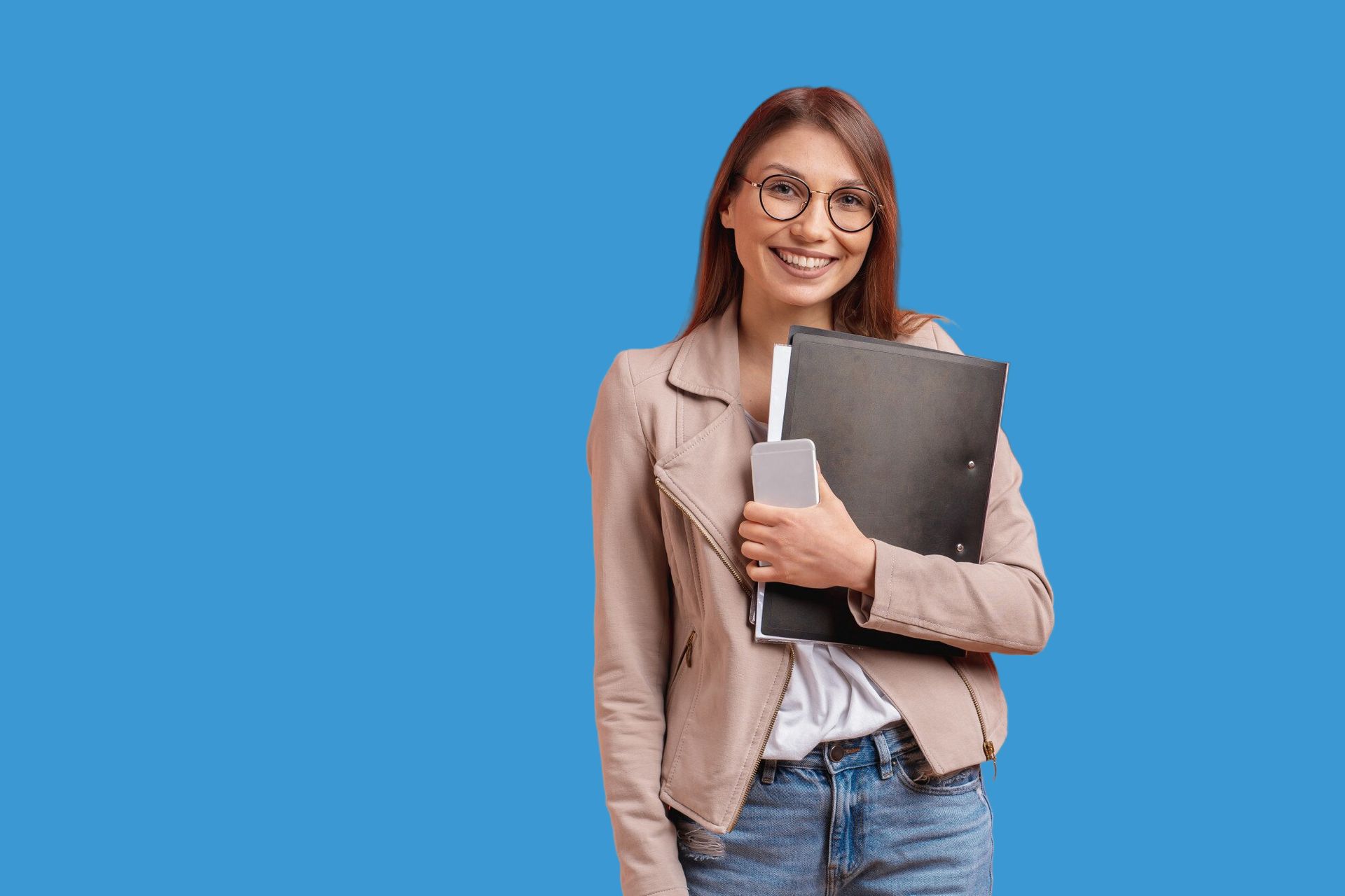 A woman wearing glasses is holding a folder and a book.