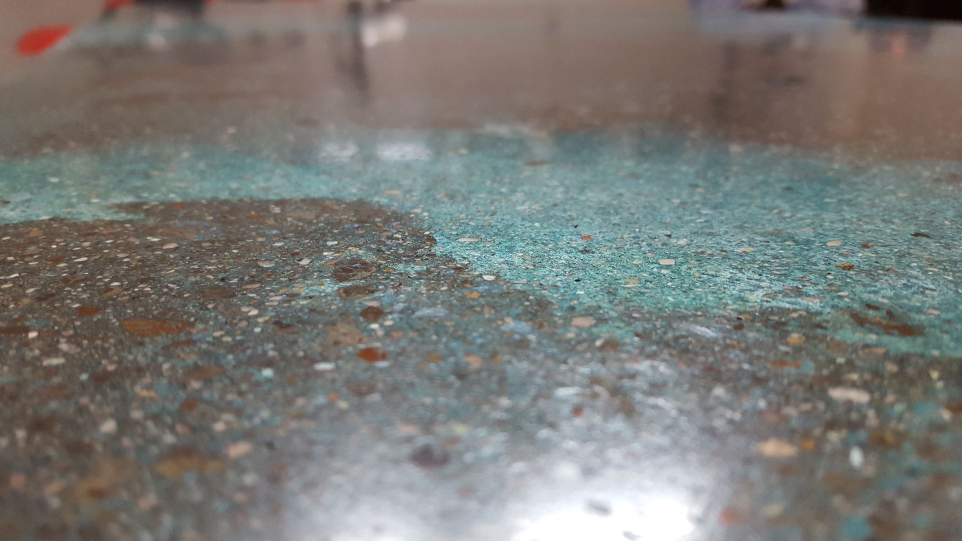 A close up of a broken glass on a concrete surface.