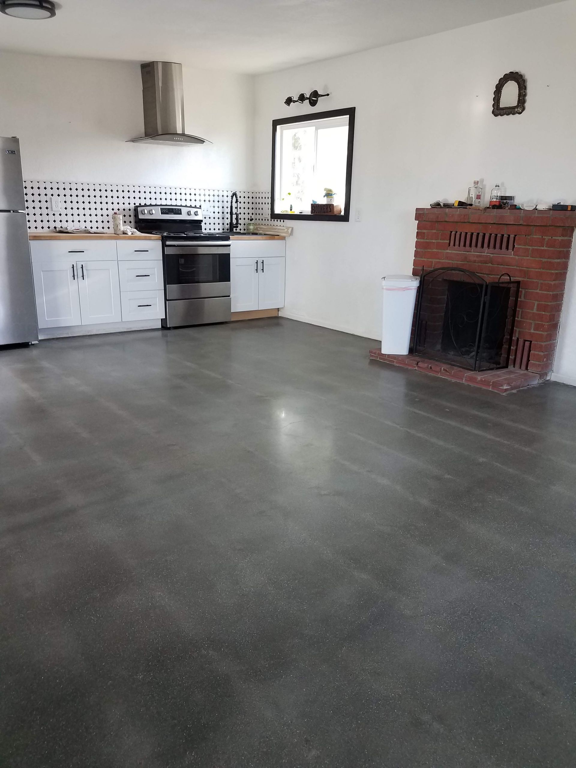 A kitchen with a fireplace and a refrigerator