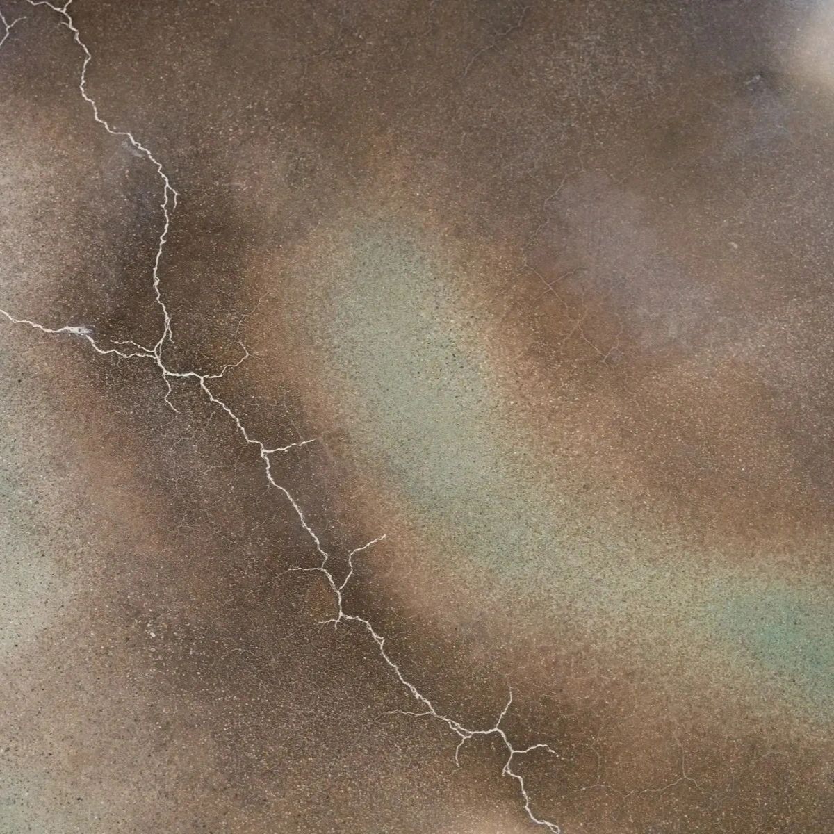A close up of a cracked concrete surface