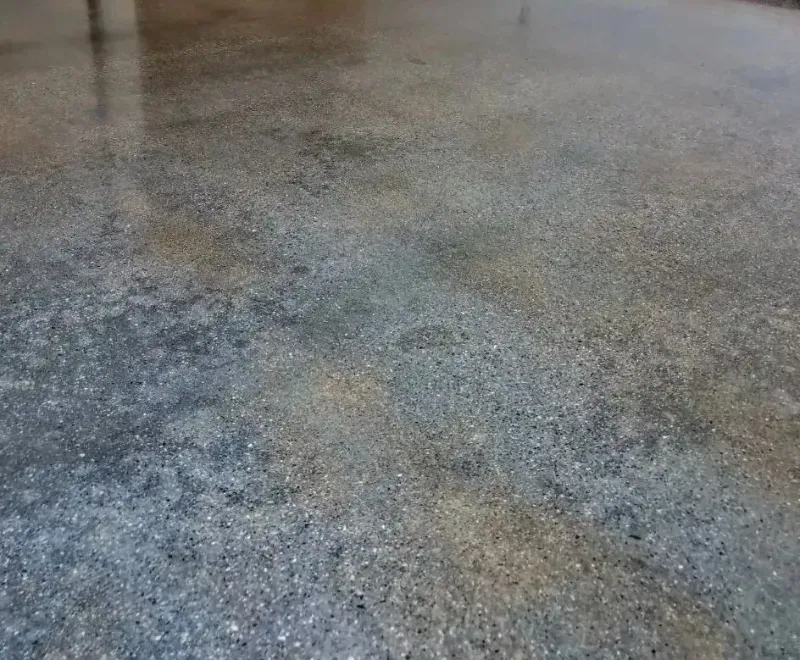 a close up of a polished stained concrete floor with a lot of small stones on it in La Quinta CA.