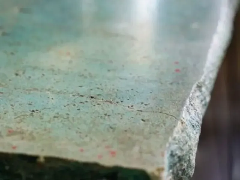 A close up of a piece of glass on a table.