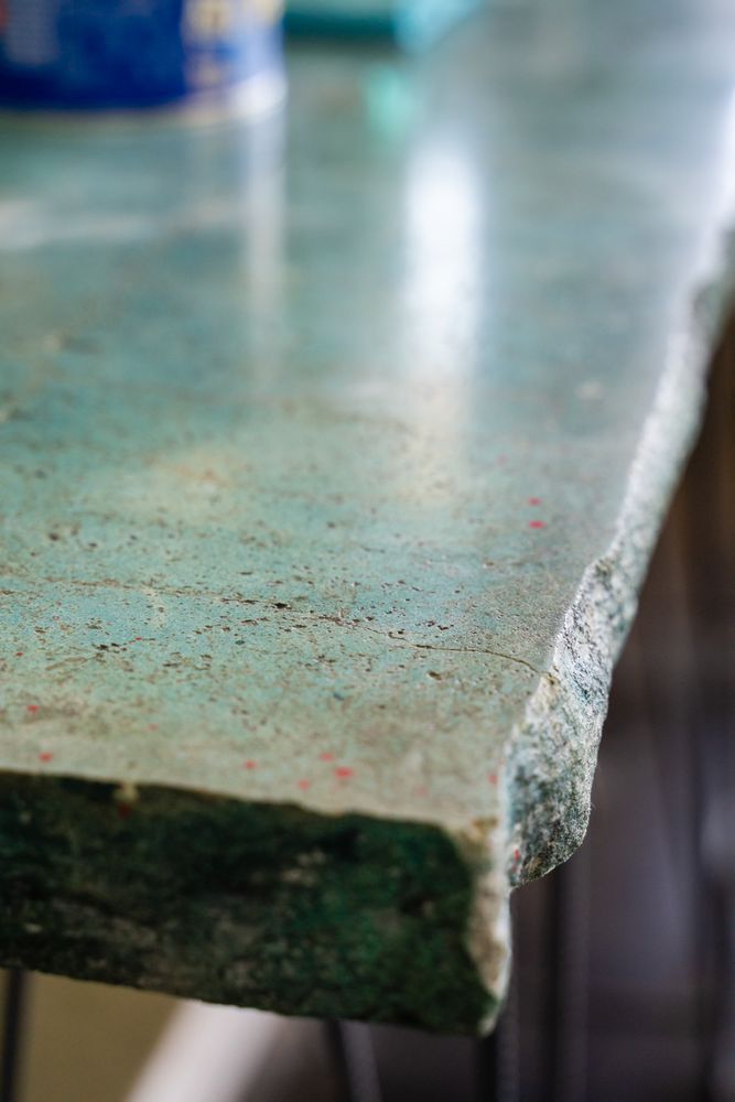 A close up of a green marble counter top.