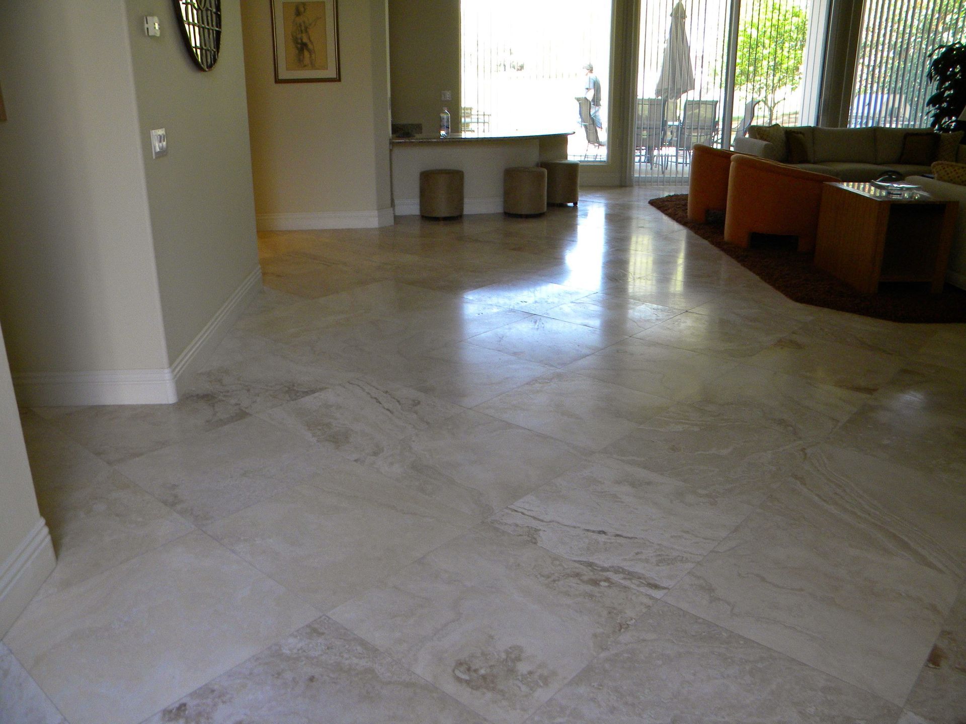 A living room with a marble floor and a couch