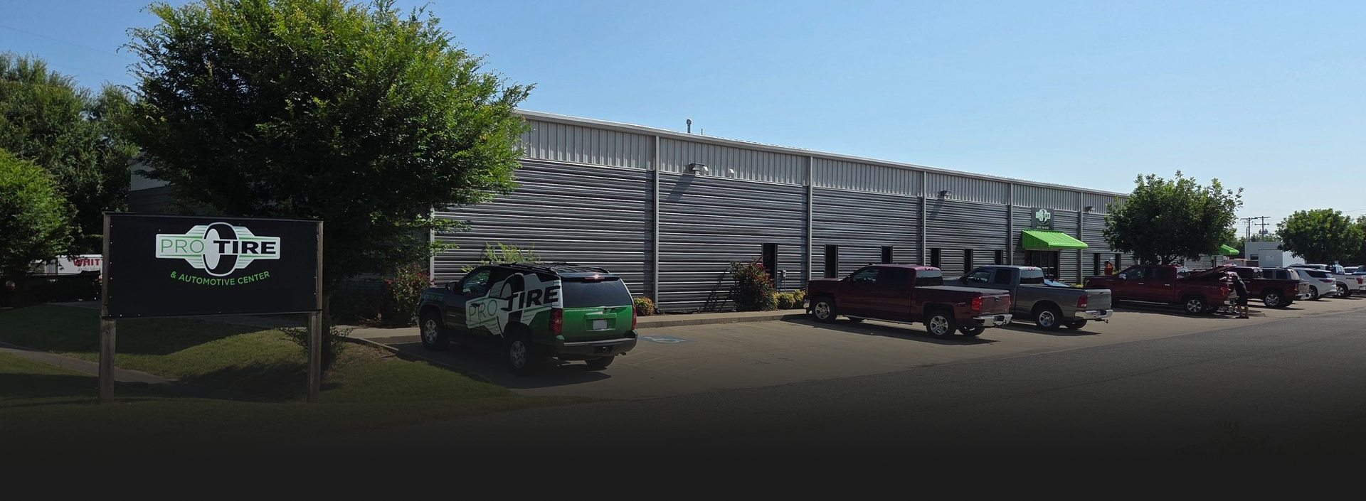  large building with parked cars. | Pro Tire & Automotive Center