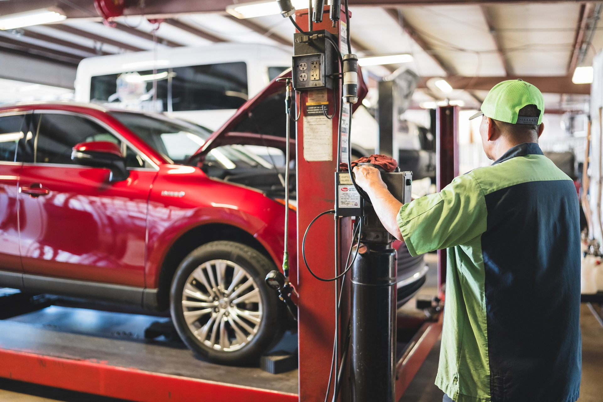 Mechanic  working on a red car  in a repair shop | Pro Tire & Automotive Center