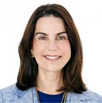 Barbara Goldberg Goldman wearing a blue jacket and a blue shirt and smiling for the camera.