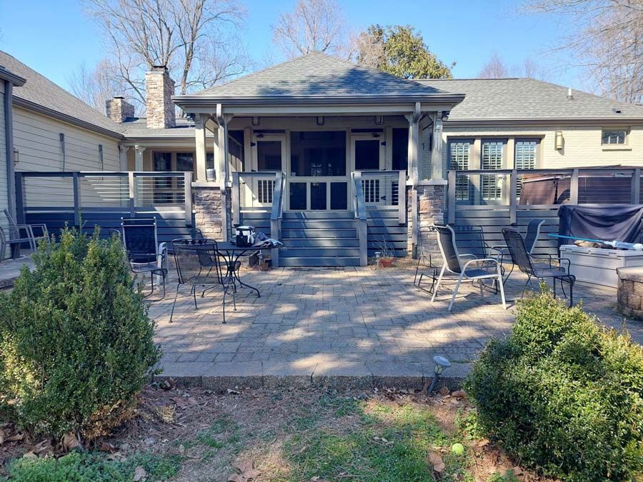 The backyard of a house with a patio and a fire pit.