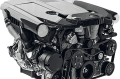Close-up of a shiny black car engine with visible pulleys, belts, and metallic components | Trask Automotive