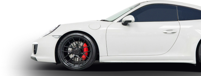 White sports car side view with black wheels and red brake calipers | Trask Automotive