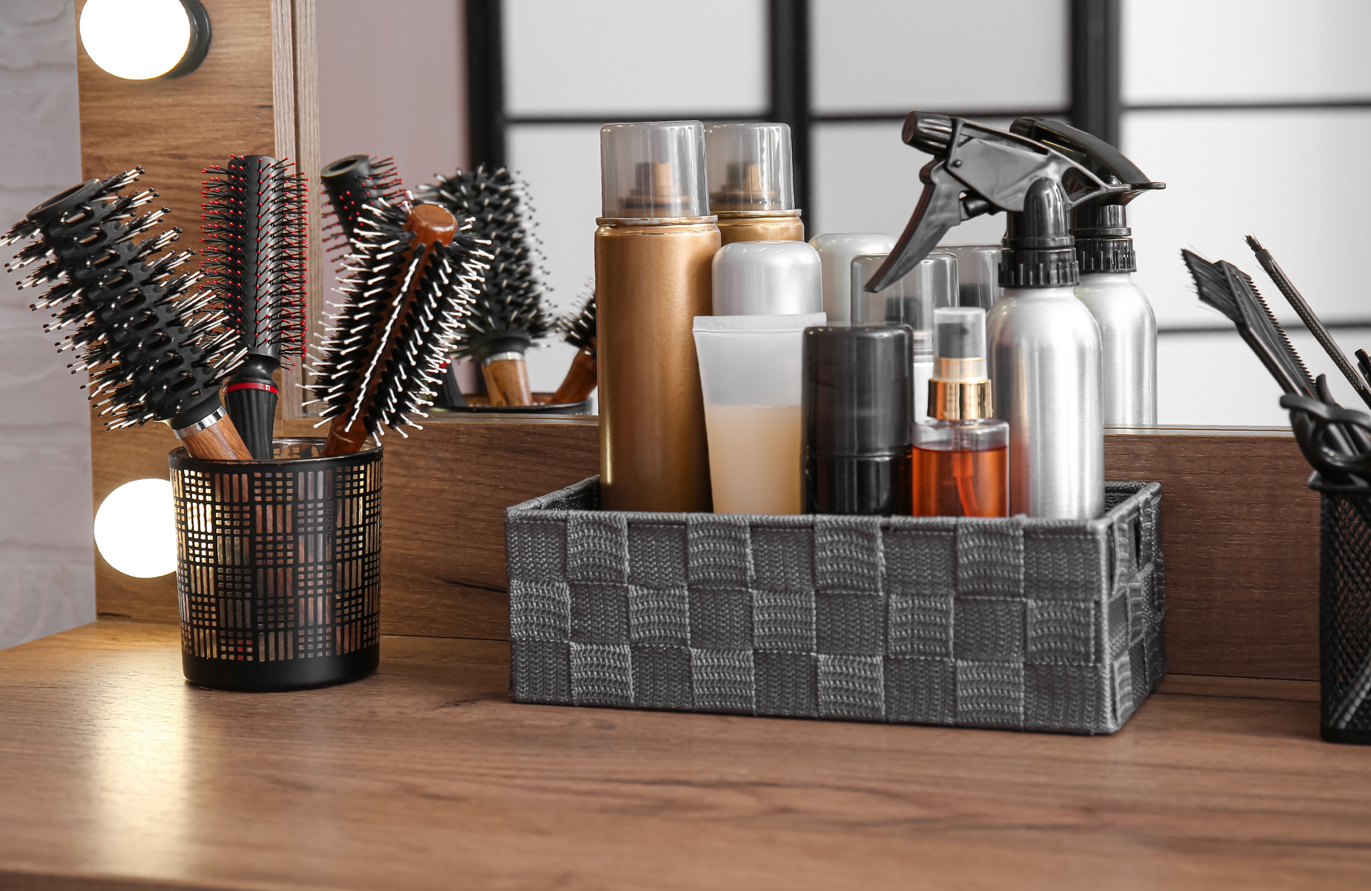 A wooden table with brushes , spray bottles , and cosmetics on it.