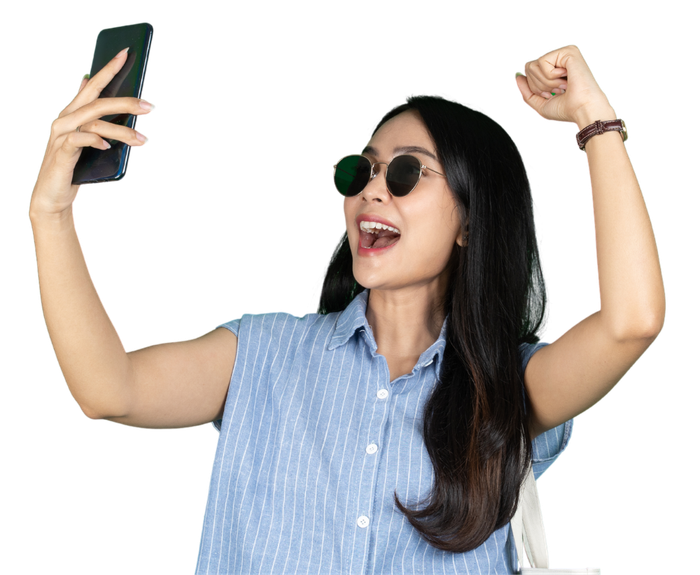 A woman wearing sunglasses is taking a selfie with her cell phone.