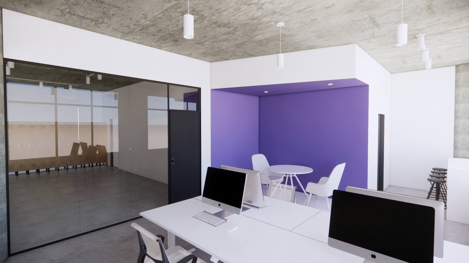 Intérieur de bureau avec un espace de réunion violet et des bureaux blancs équipés d'ordinateurs.