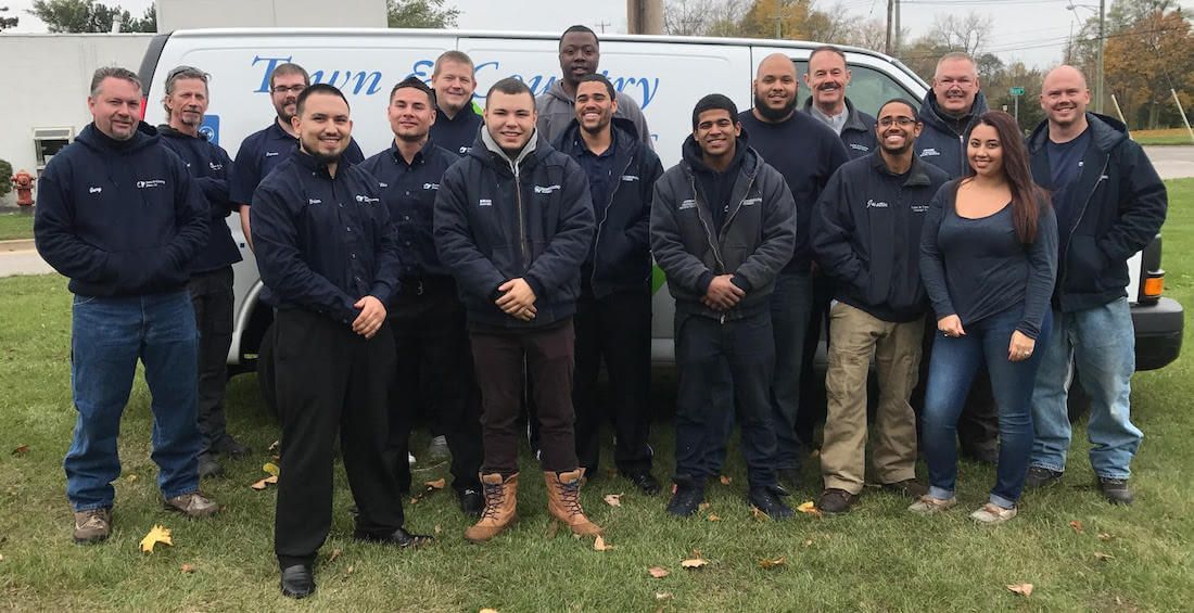 Group of people standing in front of a white van with