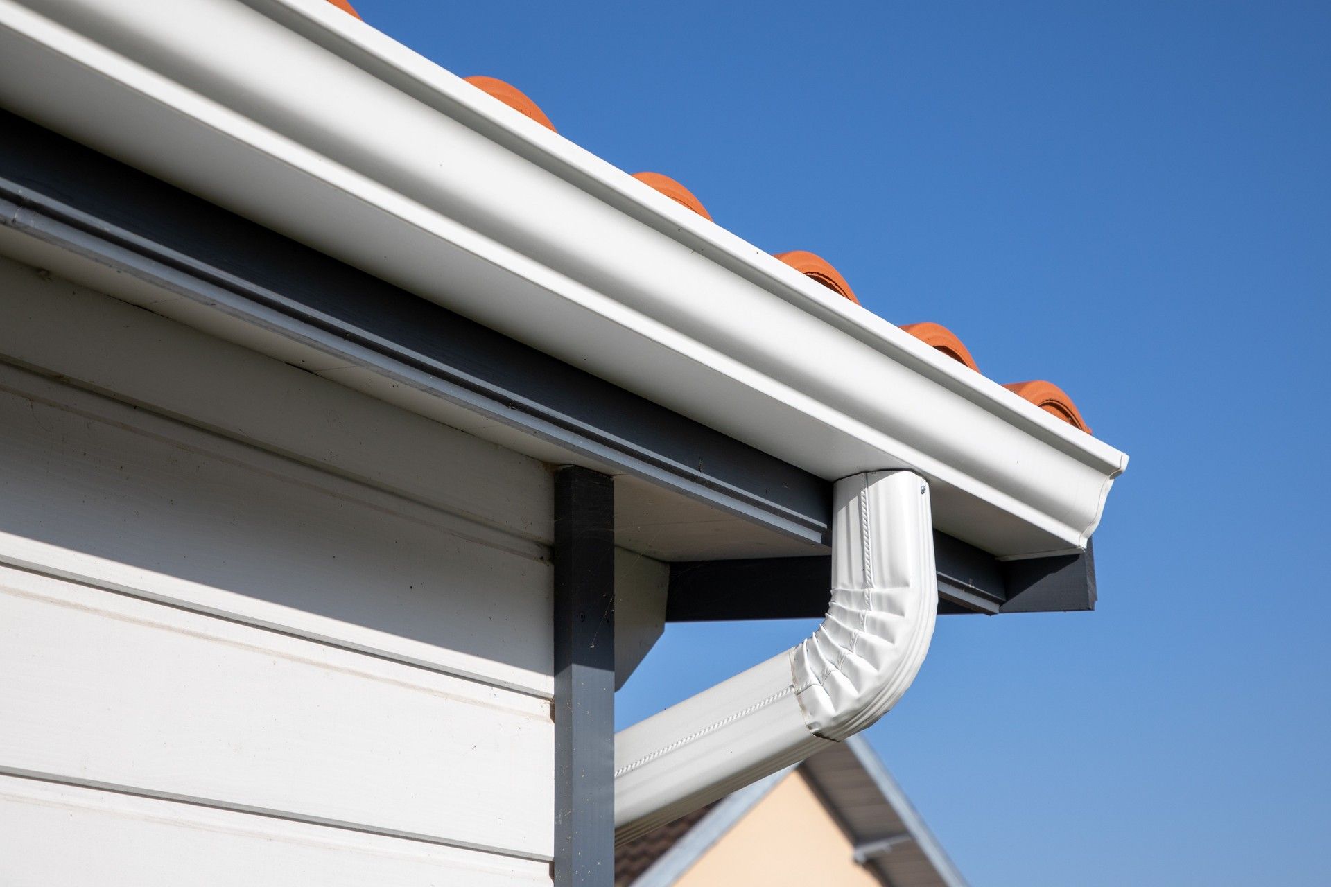 A close up of a gutter on the side of a house — Overland Park, KS — Johnson County Solutions