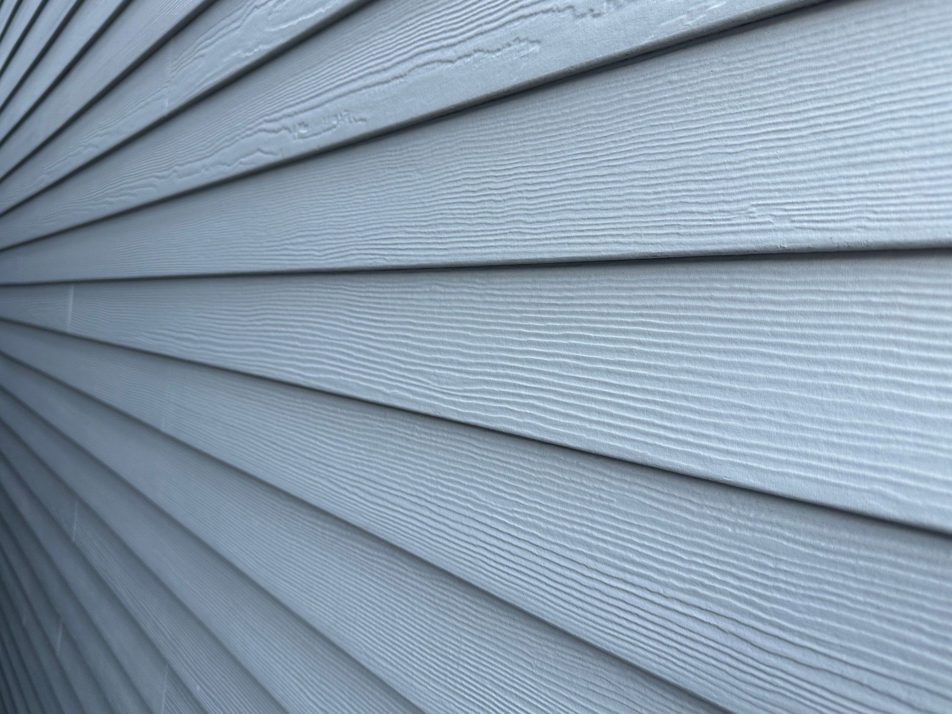 A close up of a blue siding on a house — Overland Park, KS — Johnson County Solutions