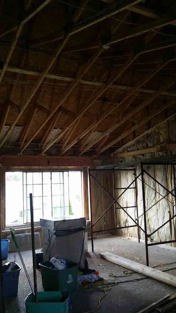 A room under construction with a lot of wooden beams and scaffolding.
