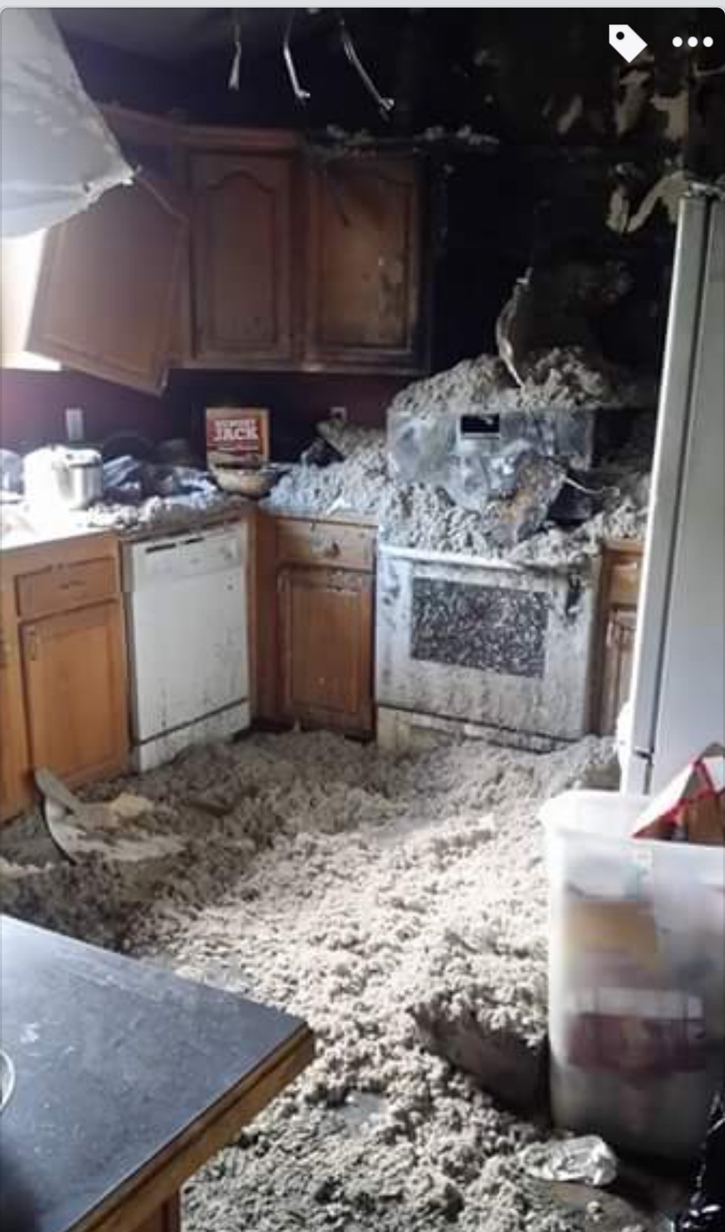 A kitchen with a lot of trash on the floor.