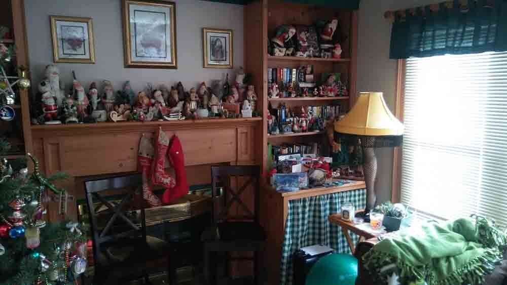 A living room filled with lots of christmas decorations and a christmas tree.