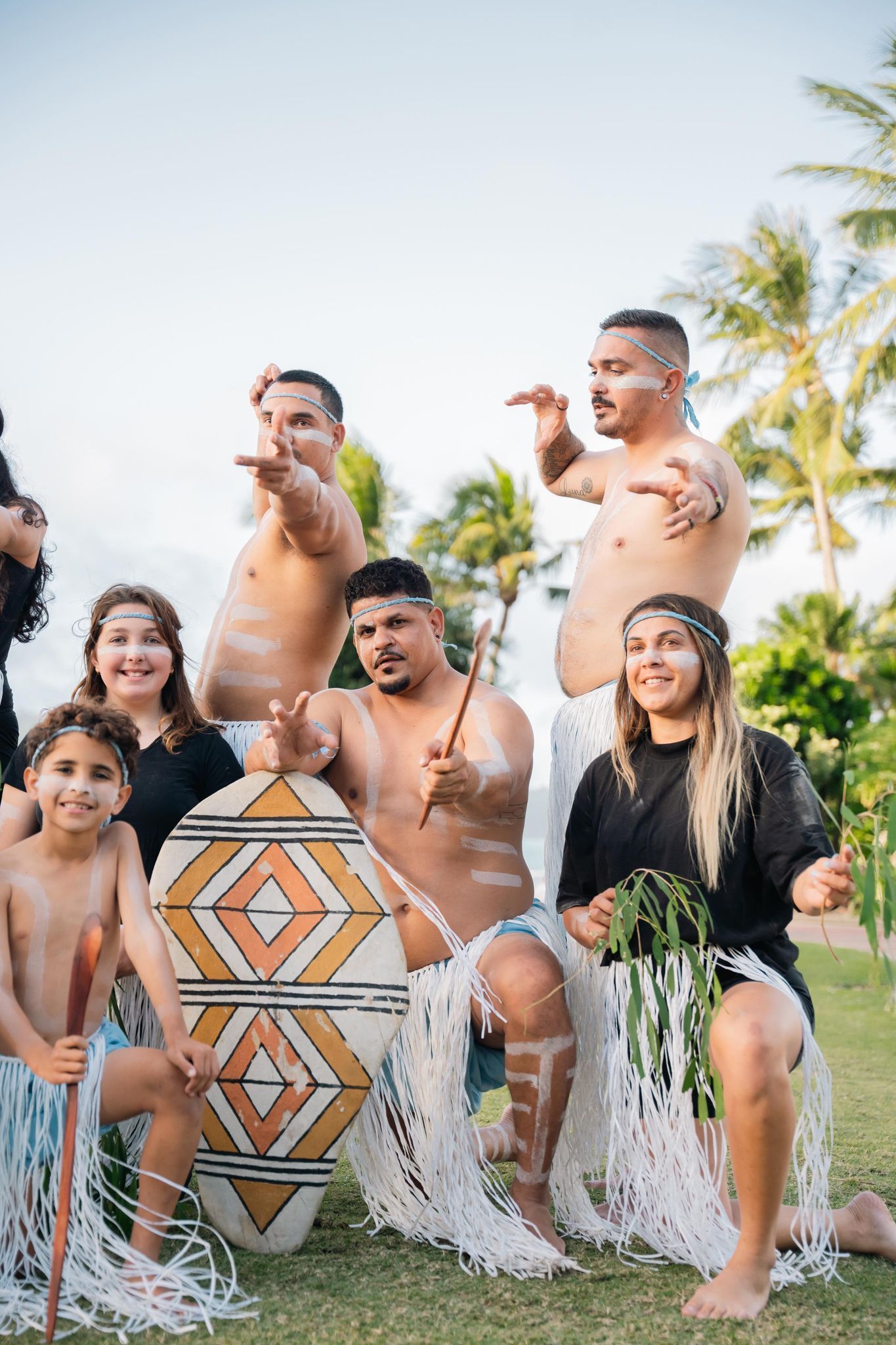 A group of people are posing for a picture in a field.