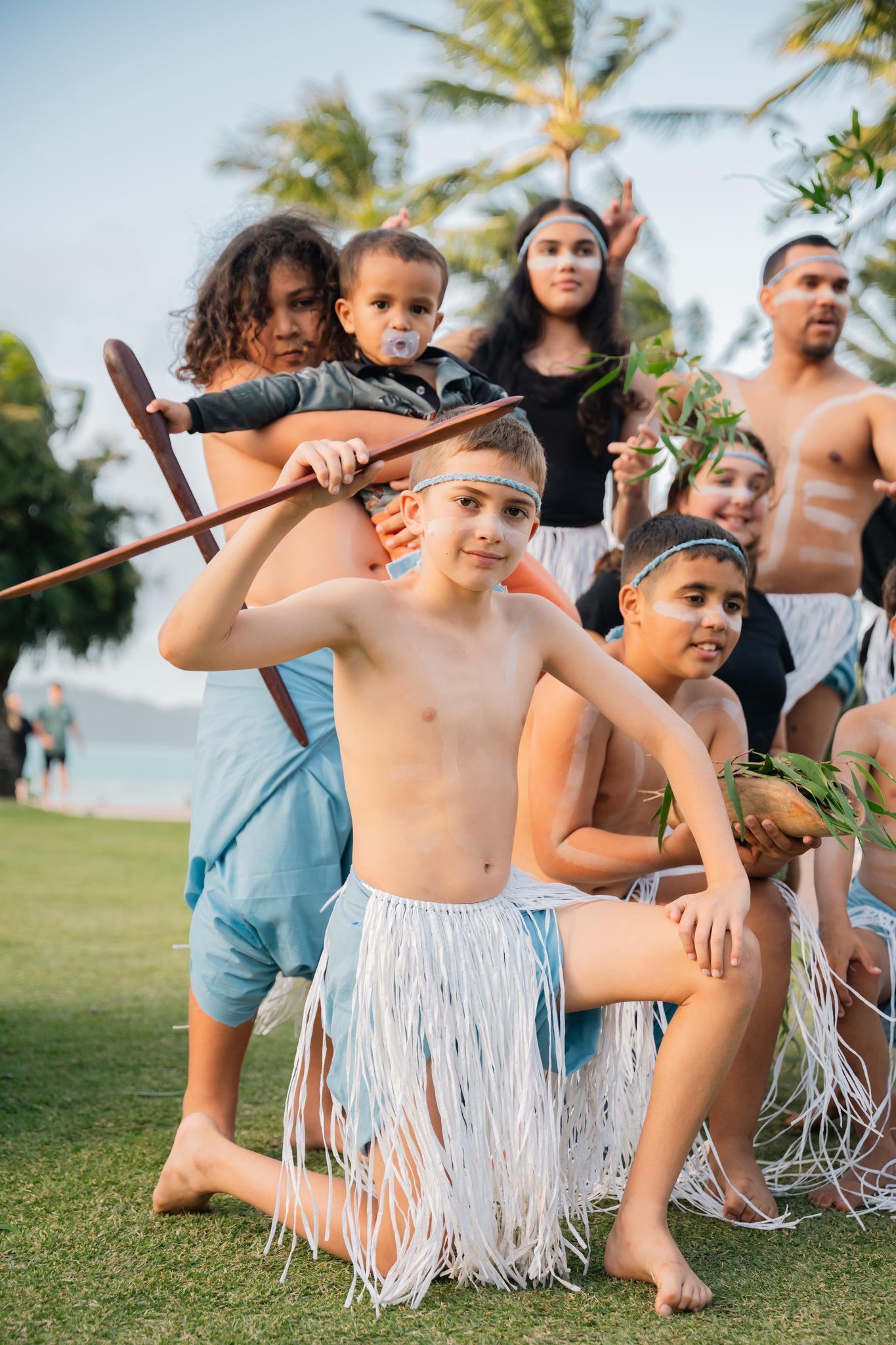 A group of children are posing for a picture in a field.