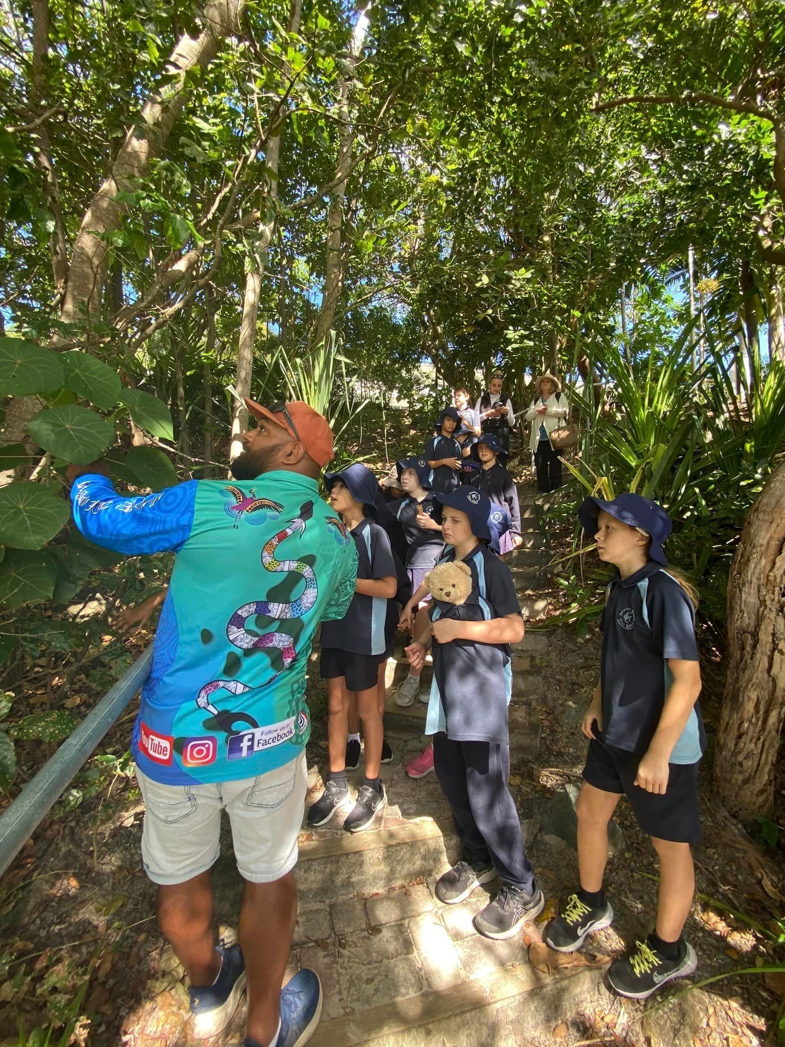 A group of children are walking through a forest.