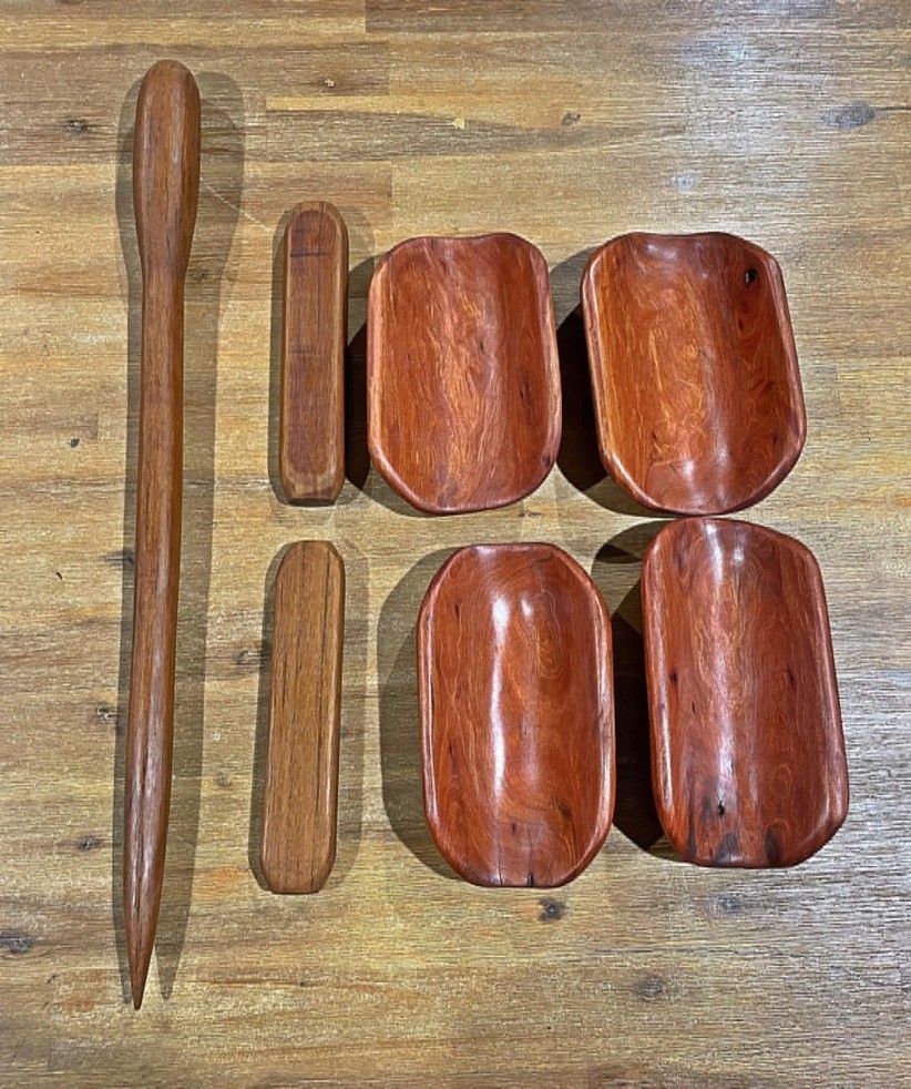 A set of wooden bowls and spoons on a wooden table.