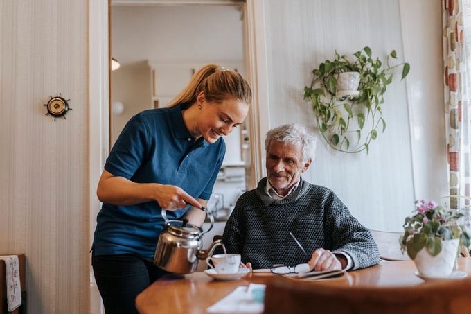 A Woman Is Pouring Tea For An Elderly Man - DeSoto, TX - Amazing Hearts Homecare & Staffing A Woman Is Pouring Tea For An Elderly Man - DeSoto, TX - Amazing Hearts Homecare & Staffing