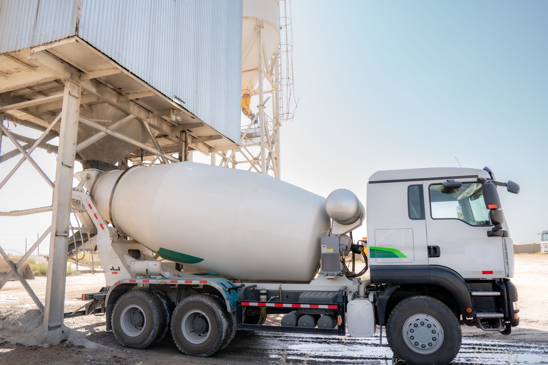 A concrete mixer truck is loading concrete mortar. A concrete mixer truck is loading concrete mortar.