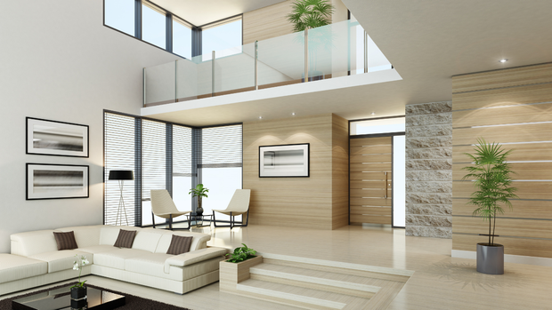 Bright modern living room with white sofas, dining area, staircase, and large windows