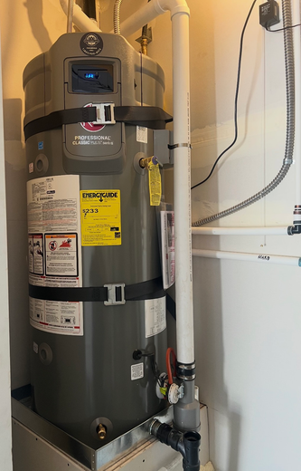 Water heater in a utility closet with pipes, valves, and labels attached to the tank.
