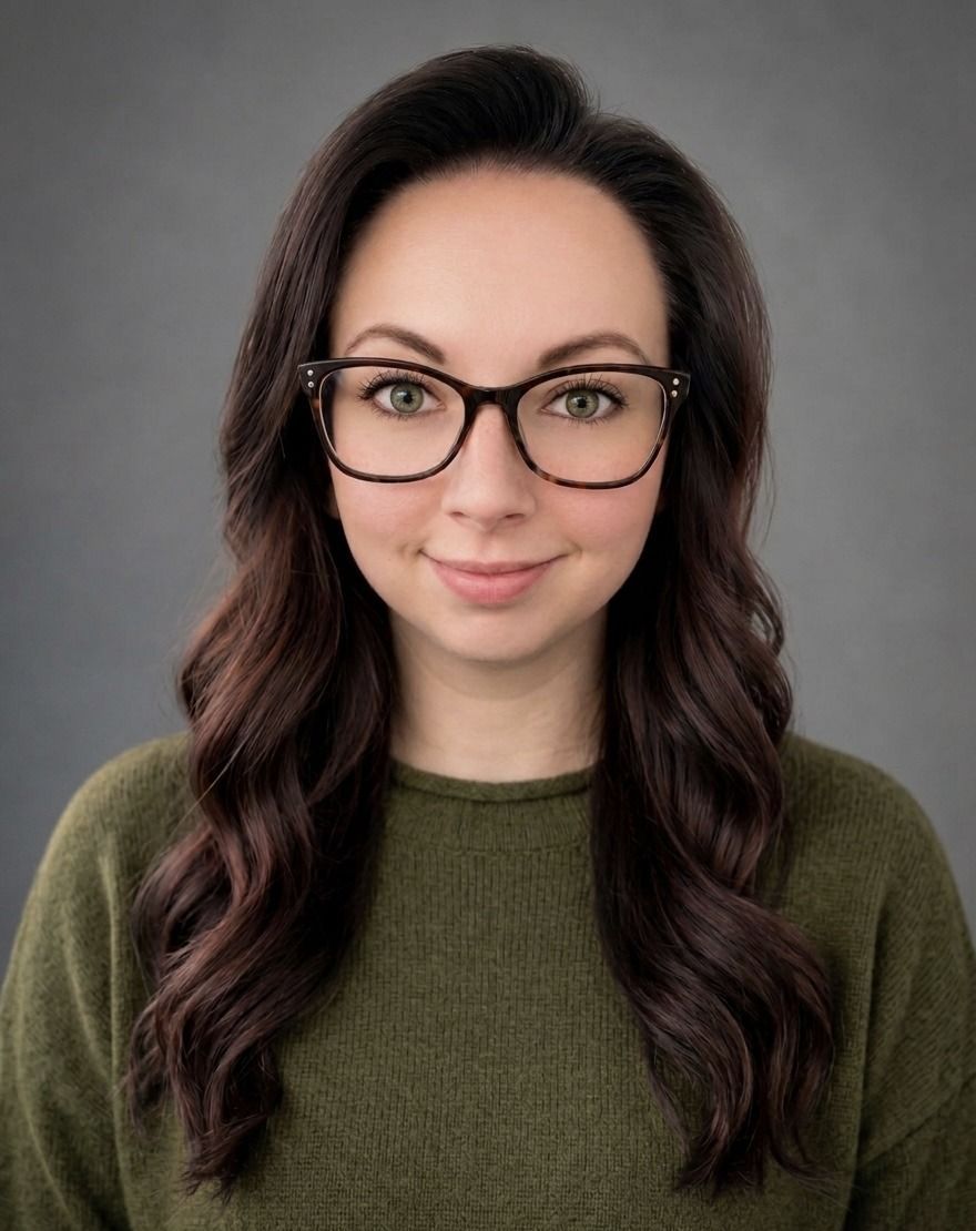 Woman with glasses, purple-ombre hair, red shirt, smiling.