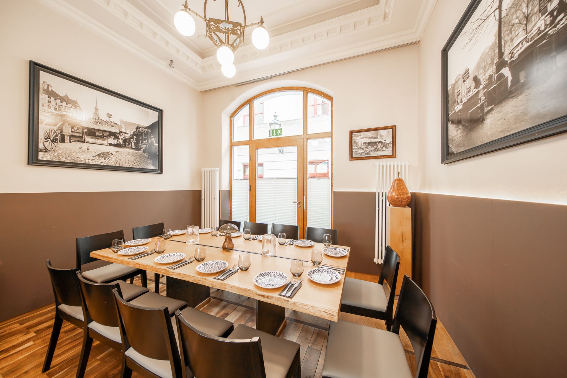 Dining room with a long table set for a meal, decorated with art.