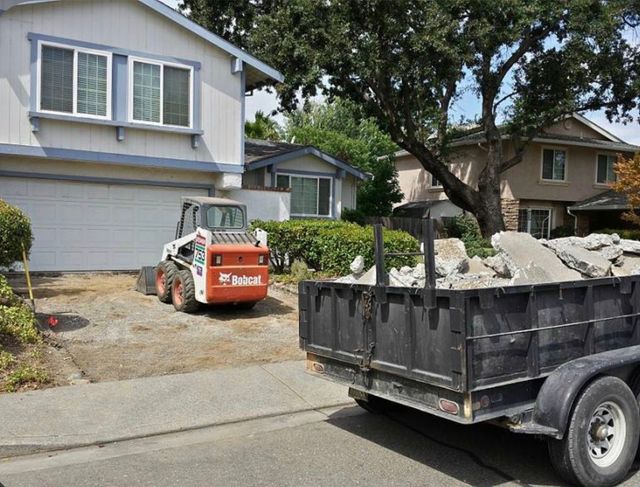 Versaship and Hauling Noco LLC trailer at a residential job site