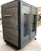 A dual-sided rolling cart with one side made of horizontal reclaimed wood planks and the other side featuring gray doors.